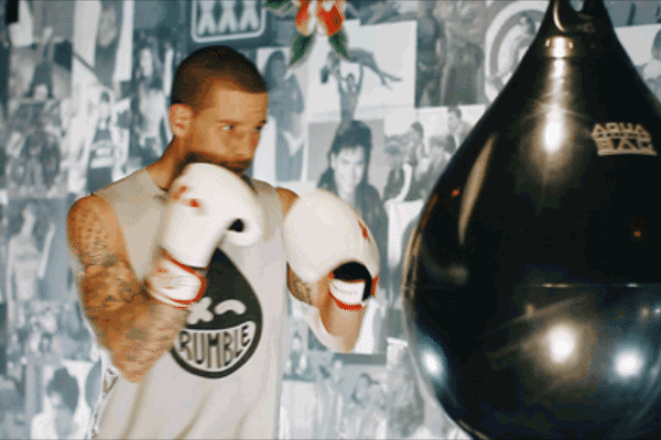 Person demonstrating front and back hooks with a punching bag