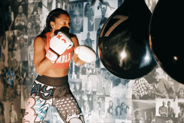 Person demonstrating front and back uppercuts with punching bag